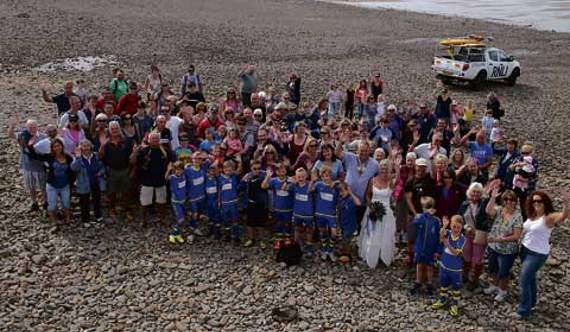 The annual Great Atlantic Walk from Crooklets beach to Sandymouth and back to Crooklets helped raise money for local charities and was organised by Bude Rotary Club. Pictured with the walkers are Bude Rotary president, Bob Willingham, and his bride of one day, Tanya, who wore her wedding dress for the occasion.