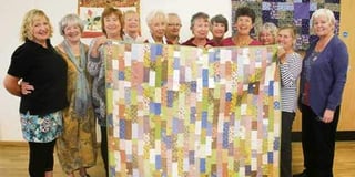 Bittersweet moment for Boscastle Craft Circle members as they auction quilt for Motor Neurone charity