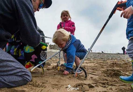 One of the younger pickers collects some waste from the sand.