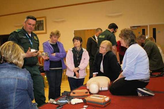 Rob Horton (SW Ambulances) tells Jean Frayn, Val Sluggett,?Annette Hutchings and Bev Birch how to use a defibrillator.