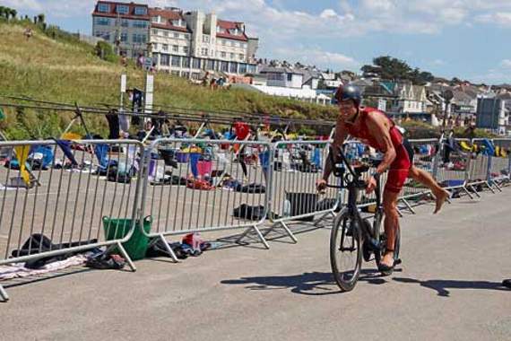 Launceston’s Simon Owens looks to dismount from the bike as he prepares to start the final leg of the Bude Marathon — a 3-mile run. Picture: Paul Hamlyn