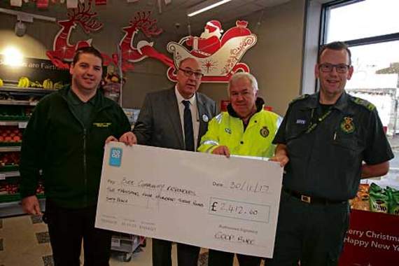 Bude Co-op manager Shaun Jackson is pictured presenting a cheque for £2,412 to Bude Responders Jamie Sprake, Graham Hodgson and Richard Waghorn.