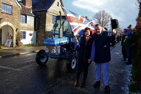 Jethro and YFC secretary Becky Dennis wave the flag to get the tractor run on its way.