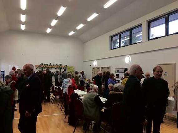 People gathered in the main hall, with stands promoting local groups.