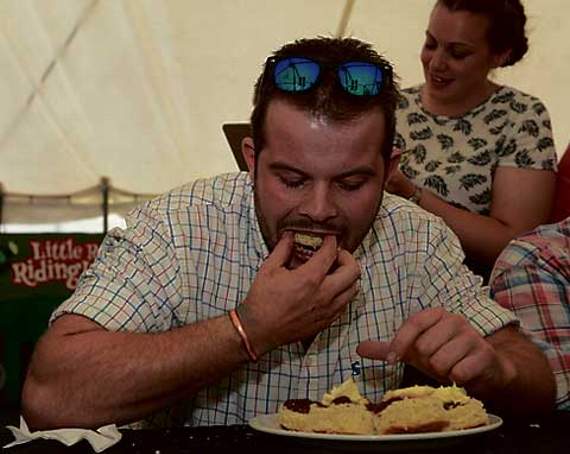 Alex Sillifant of Launceston YFC takes on the cream tea world record attempt in the YFC marquee on Saturday afternoon.