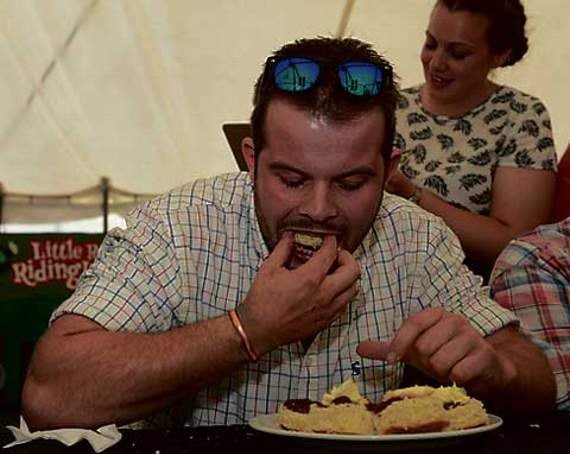 Alex Sillifant of Launceston YFC takes on the cream tea world record attempt in the YFC marquee on Saturday afternoon.