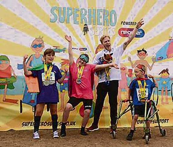 Daisy (pink) celebrates with Jonnie Peacock and her team.