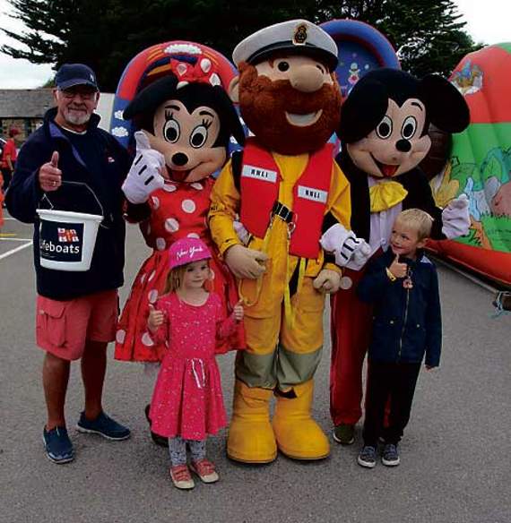 RNLI mascot Stormy Stan is pictured with local children and Mickey and Minnie Mouse. Pictures: Paul Hamlyn