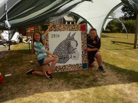 Two Year 6 leavers with the new school mosaic.