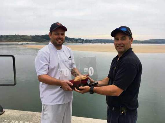 Chough Bakery’s head of pasty production Danny passes the pasty over for the first leg of its journey to Scotland.