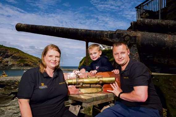 Golden Lion landlords Beth and Marc Kendall with son Kenton by the Milly’s stern gun.