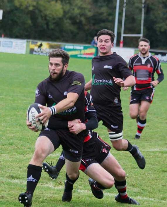 Martin Kneebone looks to keep running as he attempts to hold off a Teignmouth challenge. Picture: Paul Hamlyn