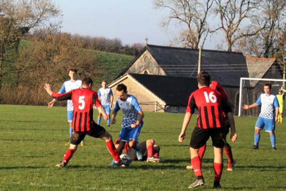 Jason Collins tries to run around the Putford defence during Bridgerule’s 4-0 victory over their visitors on Saturday. Picture: Dawn Bewes