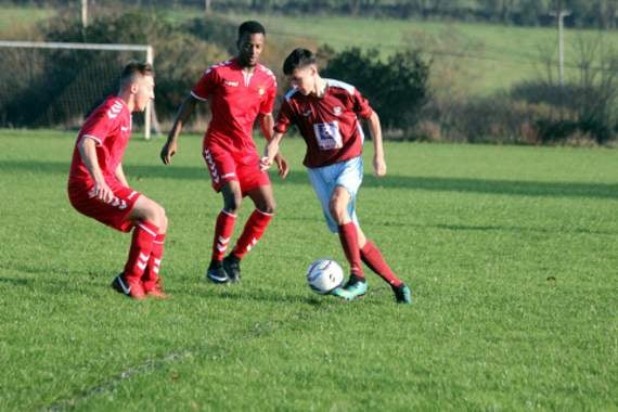 North Hill’s Kane Thomas looks to dribble past the two Saltash United defenders during their 9-1 defeat on Saturday. Picture: Paul Hamlyn