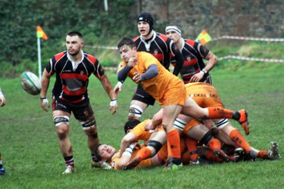 Cornish All Blacks scrum-half Tom Sandercock spins the ball out to his backs as fly-half Glenn Coles looks on.