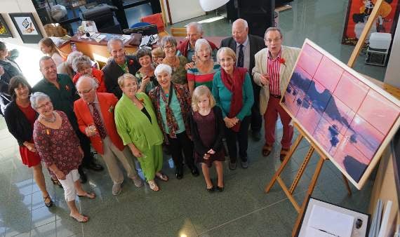 Caption: Contributing artists from Bude-Stratton Twinning Association around the surprise painting.