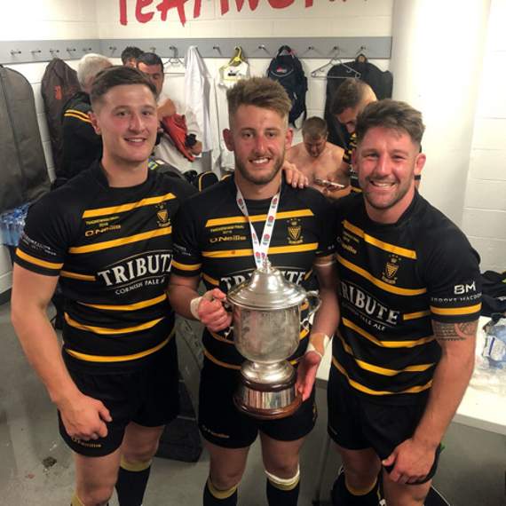 Former Launceston trio Jon Dawe, Fraser Honey and Matt Shepherd celebrate their victory in the changing rooms.
