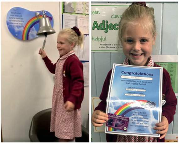 A delighted Isabel ringing the bell to signal the end of her treatment.