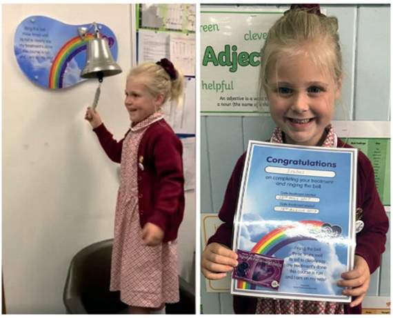 A delighted Isabel ringing the bell to signal the end of her treatment.