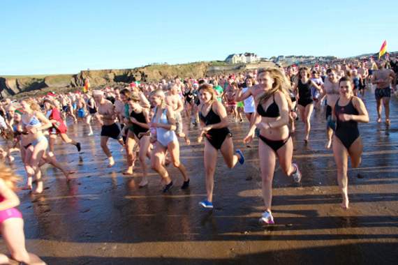 Swimmers head for the sea.