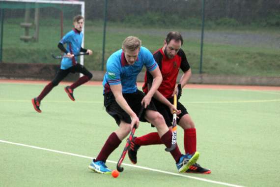 David Woodward looks to control the ball as a Devonport Services player looks to jocky him.