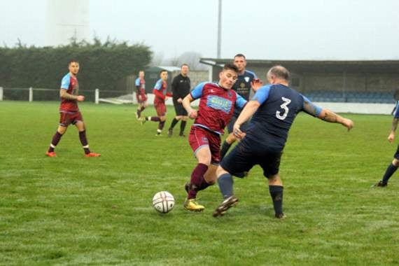 Youngster Jake Harris looks to take the ball past the St Dennis defender on Saturday. Pictures: Paul Hamlyn