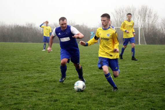 Kenny Griffin (blue shirt) chasing back for Shebbear Reserves. Picture: Dawn Bewes
