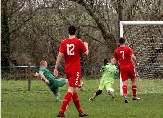 Striker Adam Price slots home his hat-trick as Tintagel recorded a crucial 3-2 victory over Saltash United Thirds at Butts Field on Saturday. Picture: David Flower
