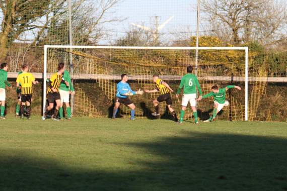 Altarnun skipper Sam Wade (yellow, centre of goal) runs off in celebration after scoring against Gunnislake. Picture: Chris Wonnacott