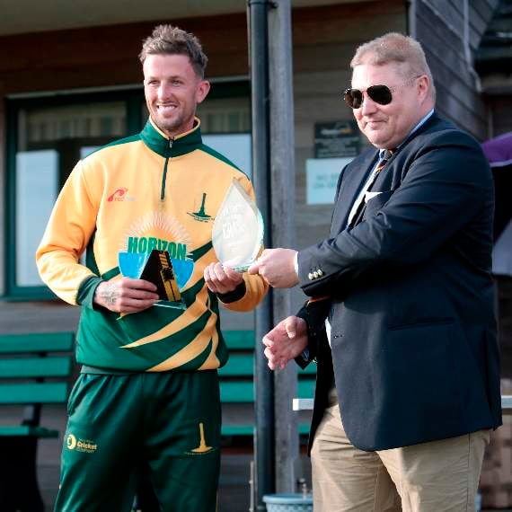 Joe White being presented the trophy by Cornwall Cricket League vice-chairman Stuart Wilder.