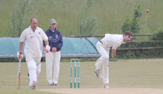 Toby Knights, who took 3-47 for Launceston, bowls as St Neot captain Andrew Tamblyn stands at the non-strikers end