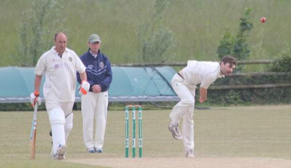 Toby Knights, who took 3-47 for Launceston, bowls as St Neot captain Andrew Tamblyn stands at the non-strikers end
