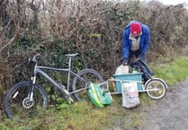 Couple tackling fly tipping on country lanes