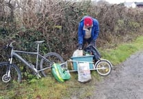 Couple tackling fly tipping on country lanes