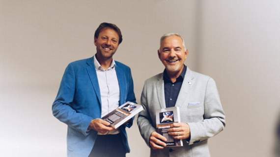 MP for St Ives Derek Thomas and Pastor David Flanders with the book