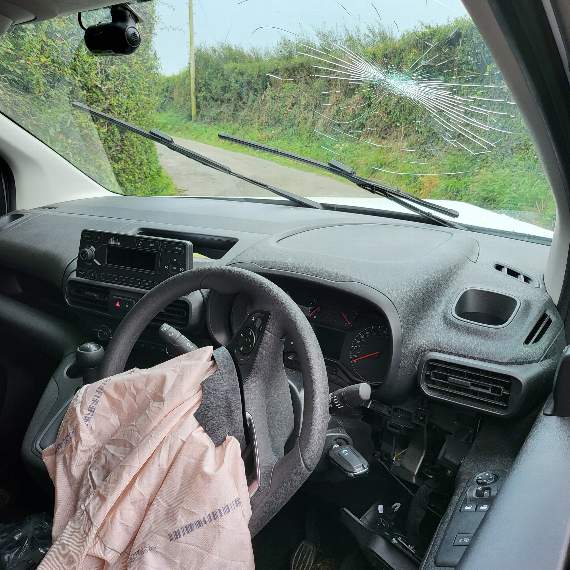 The driver hit the inside of the windscreen when the two vans collided