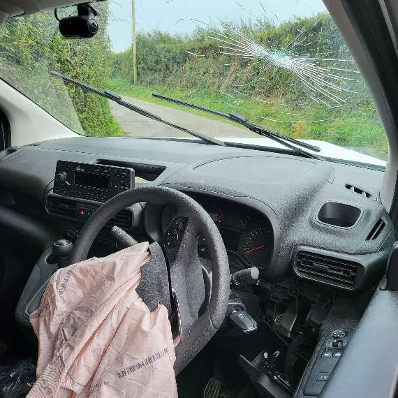 The driver hit the inside of the windscreen when the two vans collided