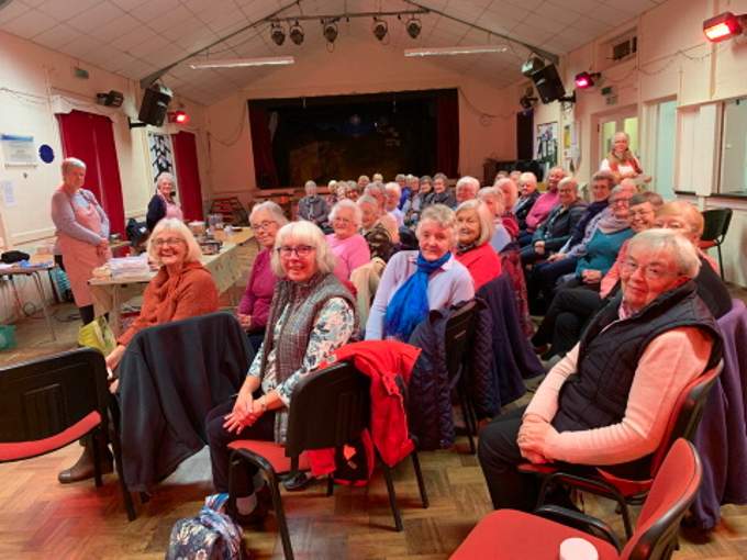 Forty local members eagerly await the start of the cookery demonstration entitled “What’s in my Trolley for Christmas 2021?” at the Coads Green Village Hall