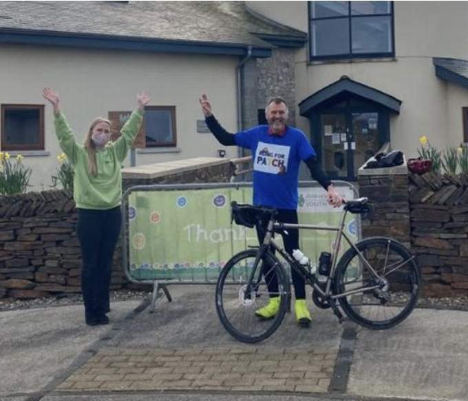 Steve Crosby receiving much-needed encouragement from Alice at the Little Harbour children's hospice in St Austell after completing the East Cornwall leg of his epic cycle ride from London to raise funds to send his little two-year-old grandson Patch to Canada for treatment.