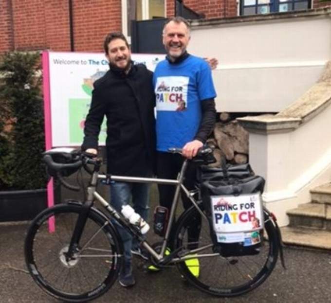 Steve being seen off at the start of his epic ride by son Dave outside the Children's Trust building in London.