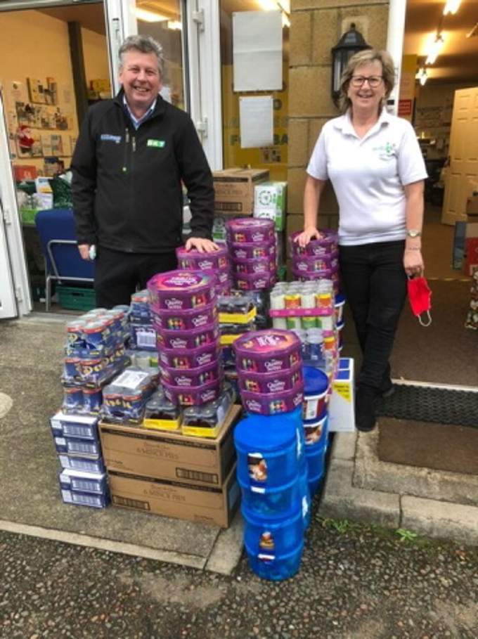 Alec Mist, sales manager for the south for R H Claydon Ltd, presents part of their £3,000 donation to Launceston Foodbank general manager Yvonne King