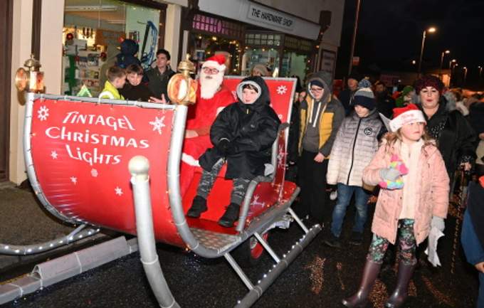 Riding along with Santa is William-Coshall Browna as they make their way to the square for to illuminate the tree
