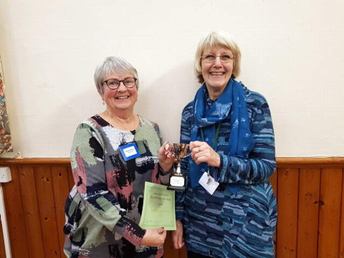Eileen Harris, competition coordinator presents Heather Stephenson with the flower of the month trophy