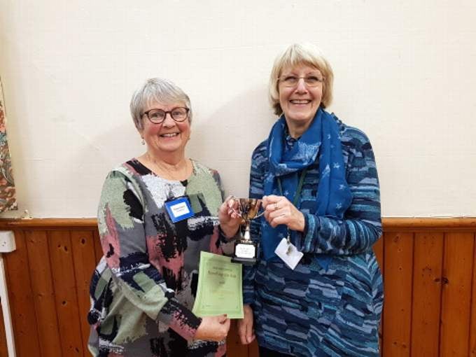 Eileen Harris, competition coordinator presents Heather Stephenson with the flower of the month trophy