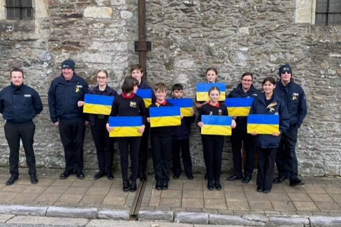 Young people from Saltash showing their support for the people of Ukraine with displays of that country's flag before the start of the walk across the Tamar Bridge. Picture: Sue Hooper
