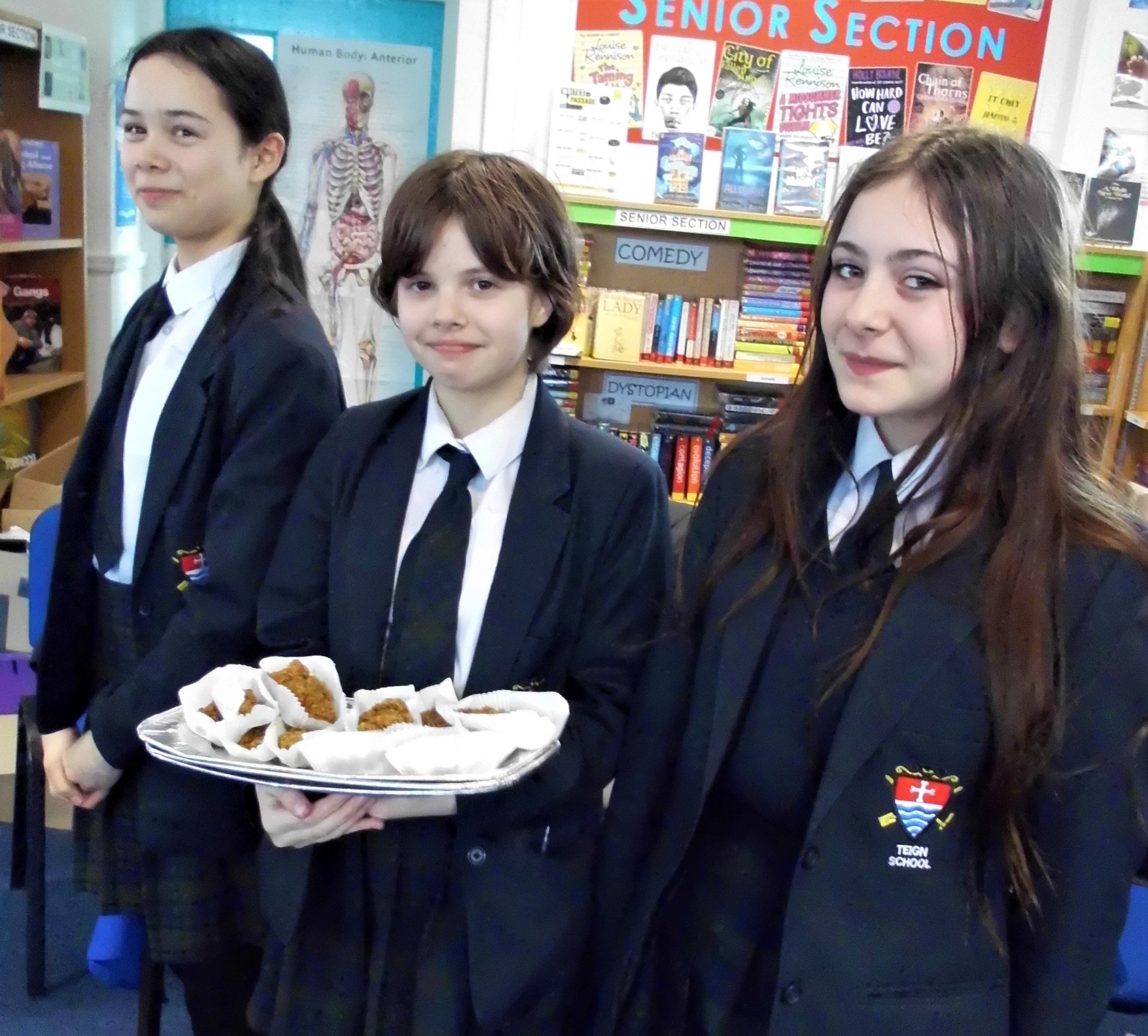 The Teign School Year 8 cake bakers Madison B, Marianne B and Katie S.
RIGHT: Teign School books for sale in aid of the Red Cross Ukraine Emergency Appeal.