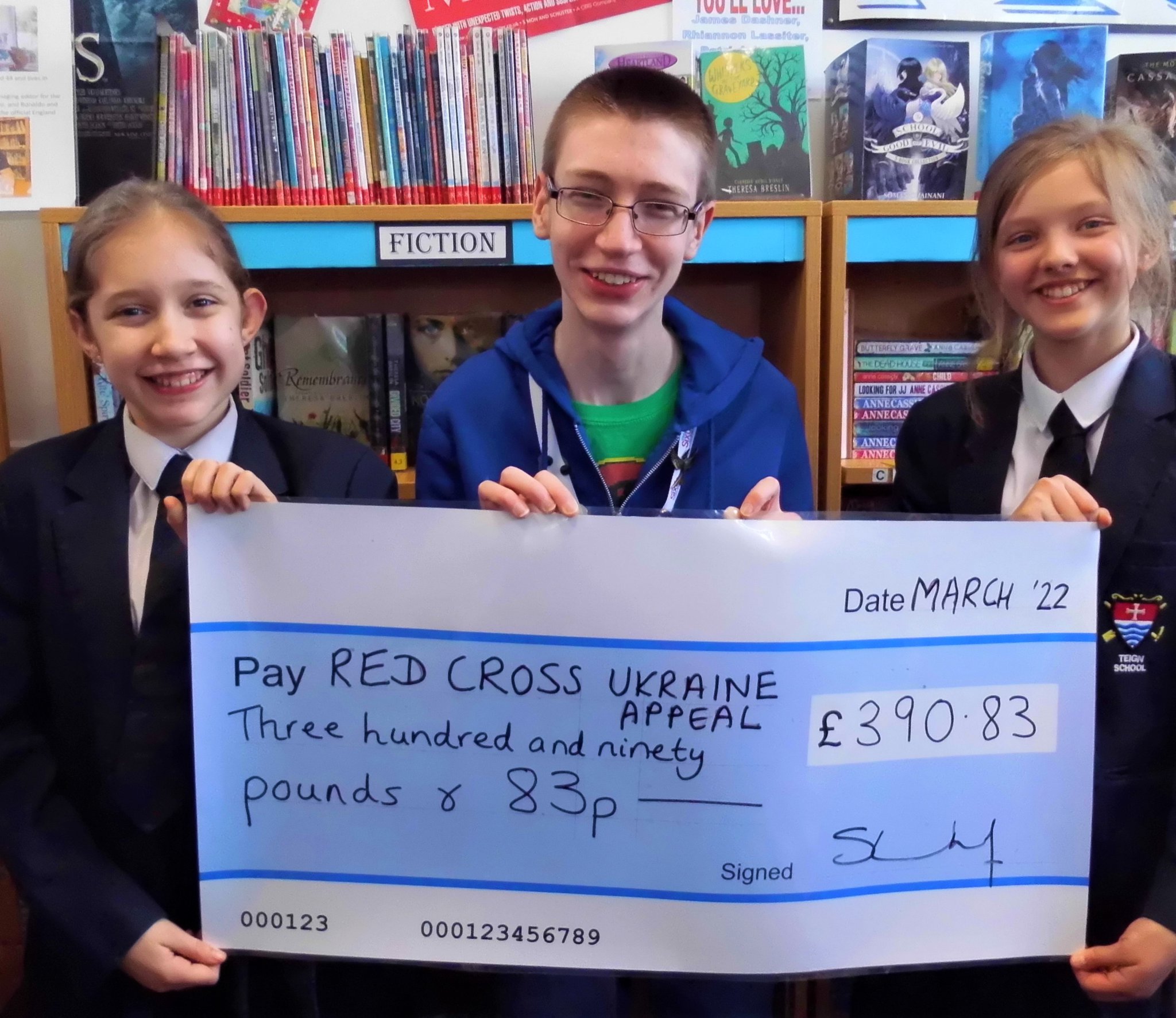 Teign School students Freya E (Year 8), Joseph B (6th Form) and Evelyn B (Year 7) proudly display our ‘Big Cheque’ for the Red Cross Ukraine Emergency Appeal.
Picture: Teign School (March 2022)
