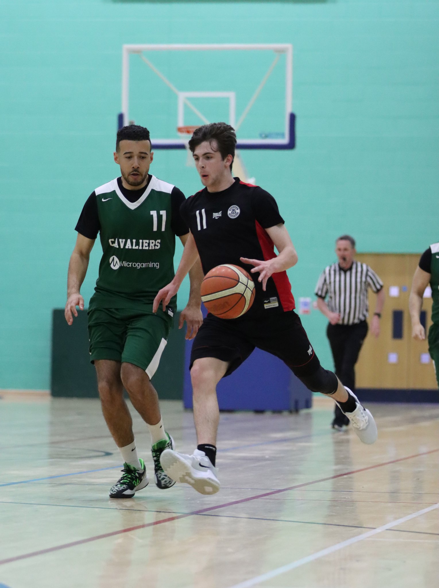 Ravens’ Conylt Dillon drives past Cavaliers’ Mike Lewis. In the end, the latter side booked their place in the second round with a 57-35 win
