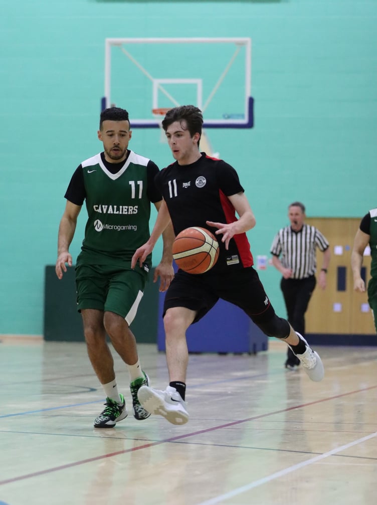 Ravens’ Conylt Dillon drives past Cavaliers’ Mike Lewis. In the end, the latter side booked their place in the second round with a 57-35 win