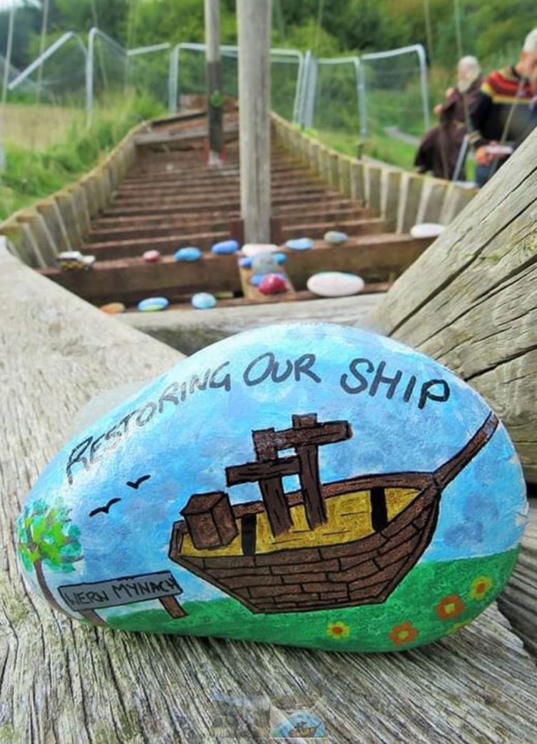 Pavlos Kyriacou and John Swift; below right, Save our ship was painted on several stones as part of a campaign to save it